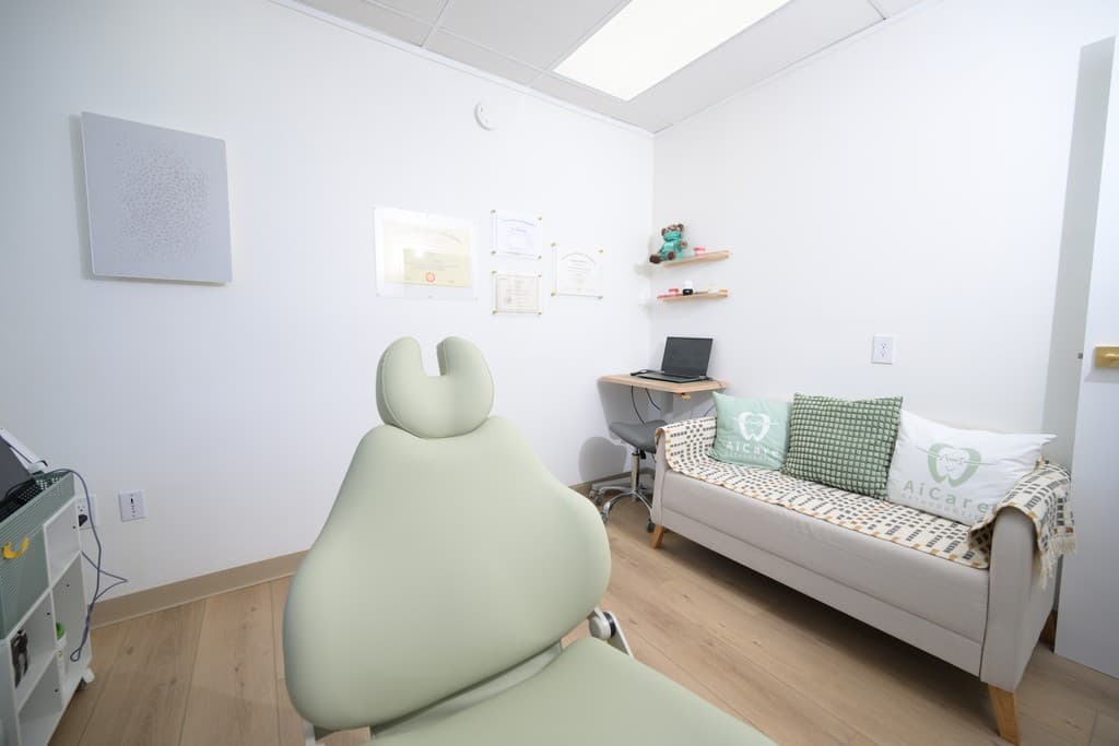 Comfortable treatment room with a green dental chair and seating for your family